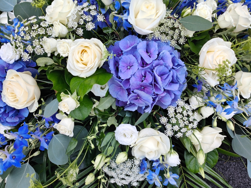 Blue and white casket spray