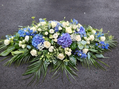 Blue and white casket spray