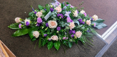 Pink and purple casket spray