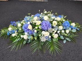 Blue and white casket spray